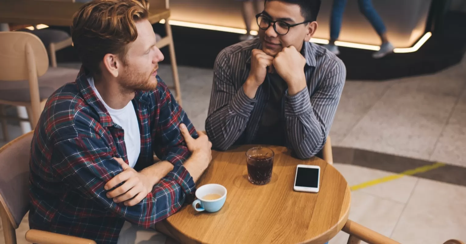 Individuals engaging in a deep conversation, showcasing humility in their communication style