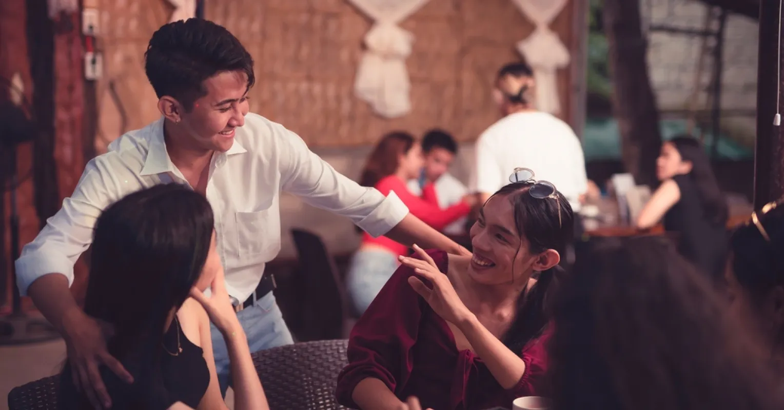 Adult engaging in conversation, showcasing improved social skills in a casual setting