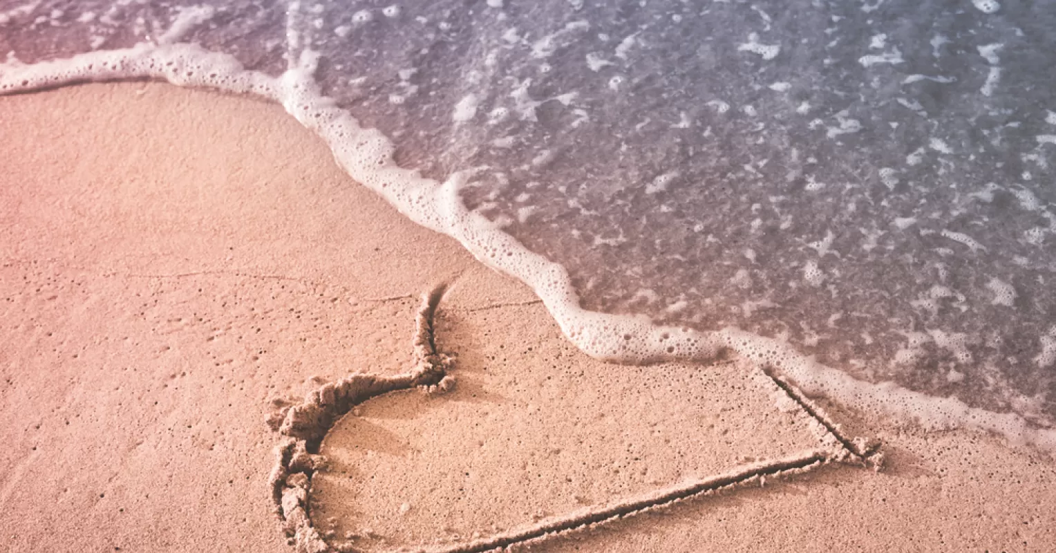Individual exploring nature and reflecting on self-discovery after a breakup
