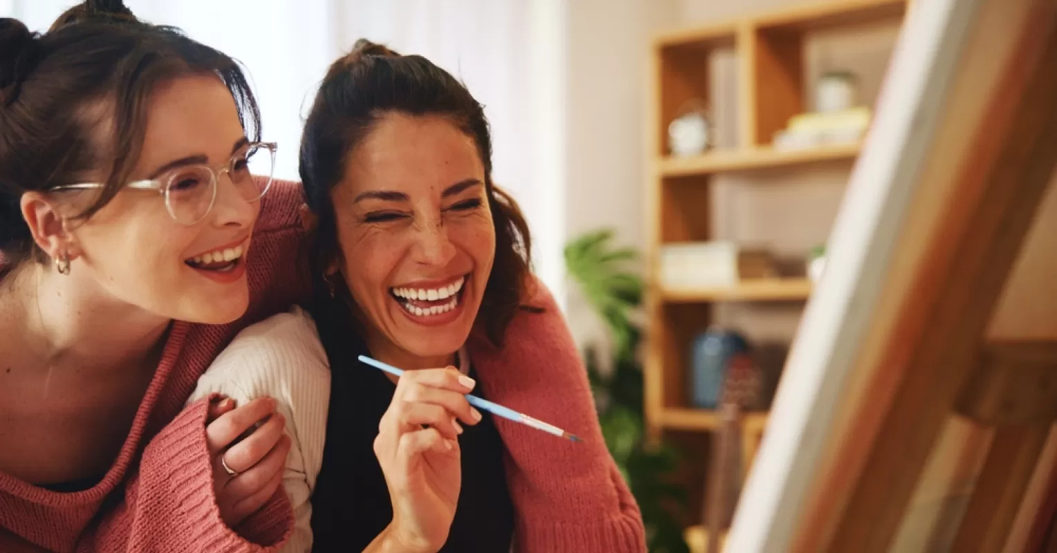 Couple sharing laughter during a cozy evening, embodying connection in long-term relationships