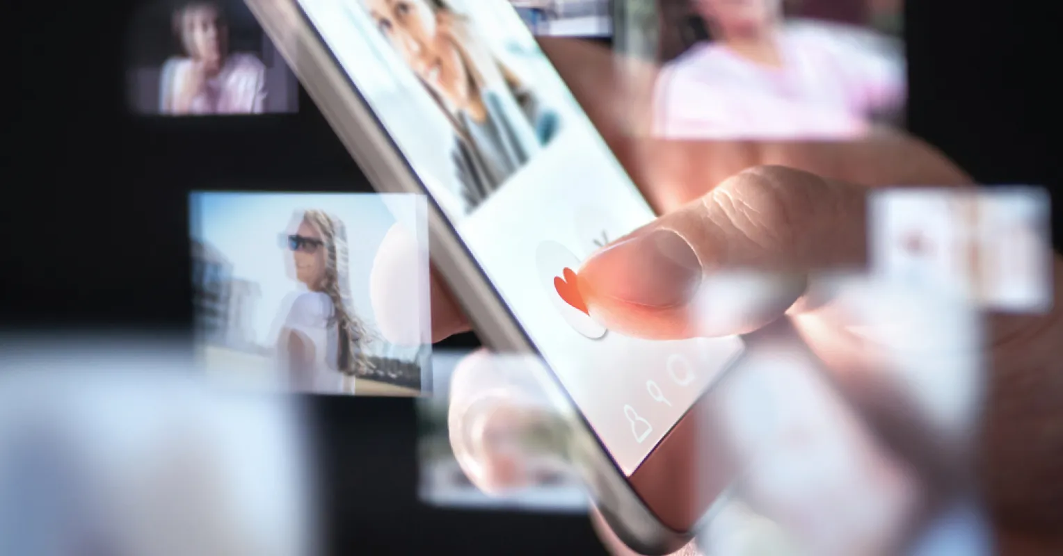 Person analyzing dating app profiles for authenticity amidst AI influences in relationships