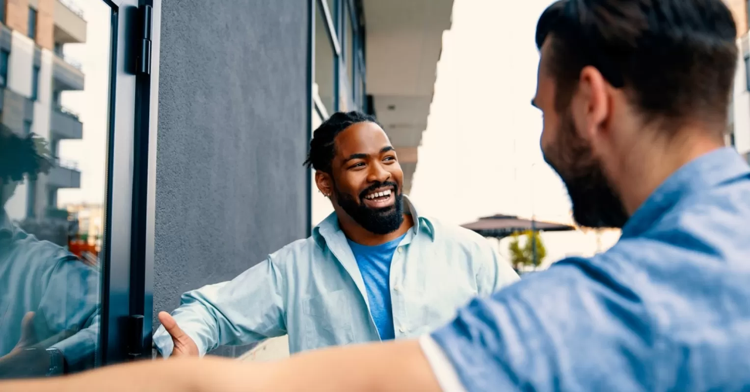 Individual observing a friend showing signs of disinterest during a conversation