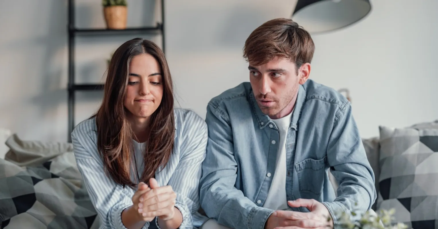 Couple discussing their feelings while facing the challenge of unrealistic expectations in marriage