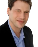 Person experiencing anxiety while watching news about global crises on a screen
