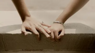 Individual experiencing anxiety while waiting for their partner's text response, reflecting on relationship signals.
