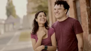 Couple sitting apart, expressing emotional distance after a disagreement.