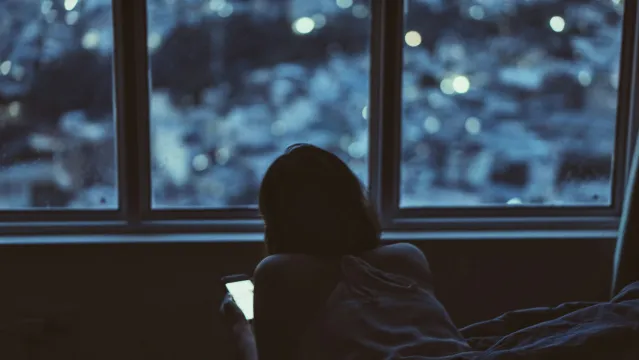 Person reflecting on uncertainty in a relationship connected to how can i tell if my partner is emotionally