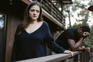 Person reflecting on uncertainty in a relationship connected to signs that my partner is fawning instead of being