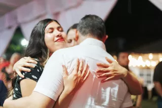 Couple reconnecting in a warm embrace after children leave home, signaling intimacy rebuild