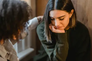 Individual looking thoughtful while struggling to express feelings in a relationship context