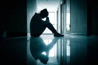 Individual hesitating to engage in a discussion about grief despite inner feelings.
