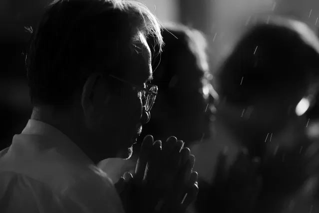 A thoughtful man sitting with a distant look, reflecting on his past relationships and emotional connections