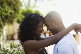 Couple celebrating achievements while contemplating future uncertainties in their relationship
