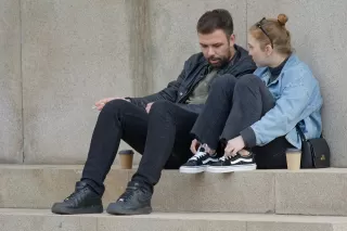 Person hesitating while sharing feelings with their partner, embodying vulnerability in love