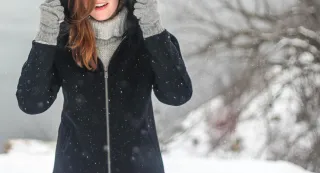 A person deep in thought during winter, considering seasonal relationship signals from an ex.