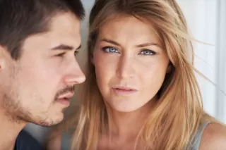 Couple pausing to reflect during an argument, highlighting relationship signals of emotional needs