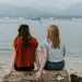 Individual reflecting on leisure guilt while enjoying a peaceful camping scene