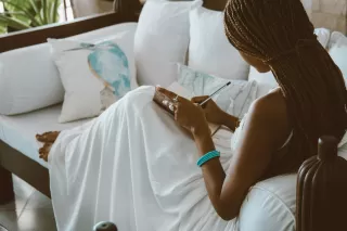 Person sitting alone, reflecting on feelings of disconnection after a breakup