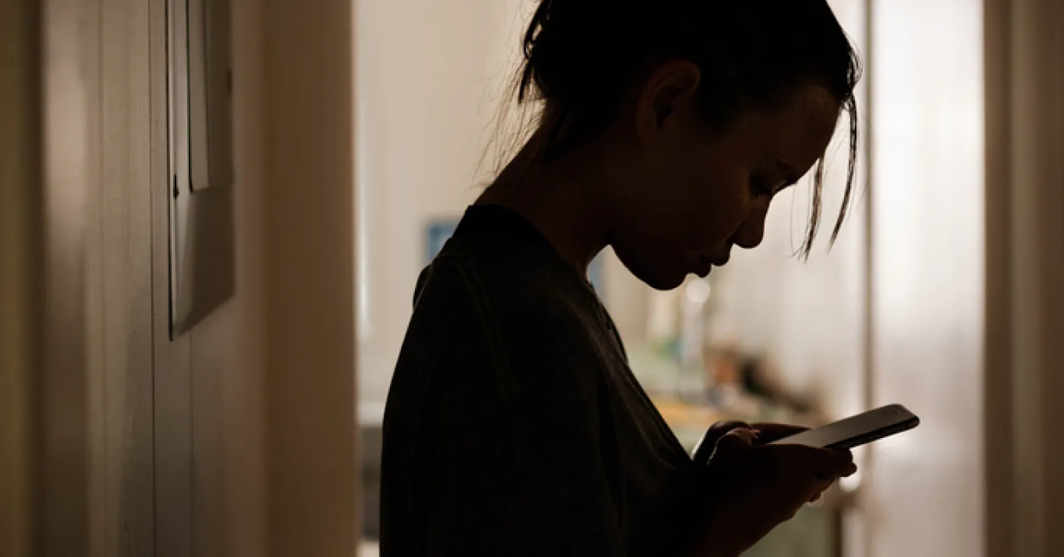 Individual contemplating fears about their partner's online behavior and relationship signals