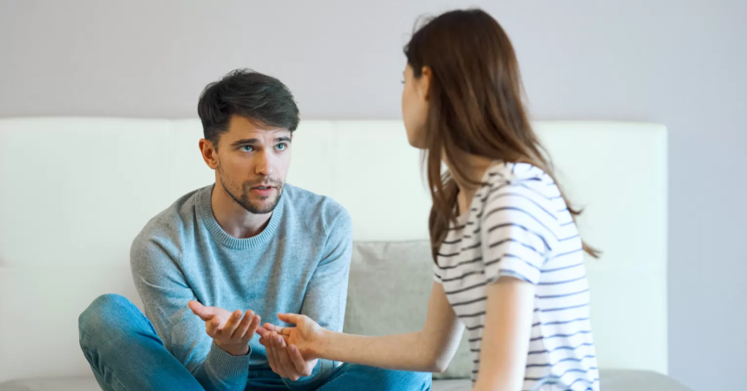 Couple having a serious discussion, highlighting signs of uncertainty in exclusivity
