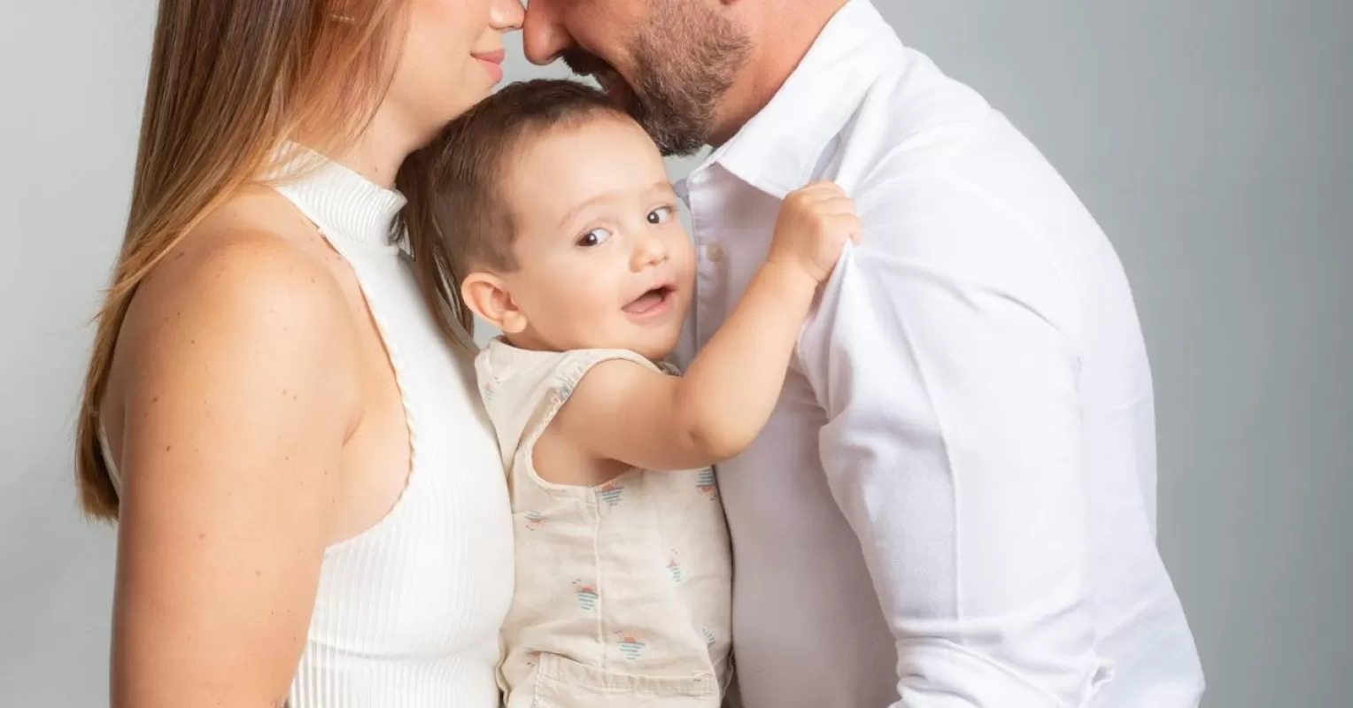 New parents showing emotional distance while sitting together but looking away from each other