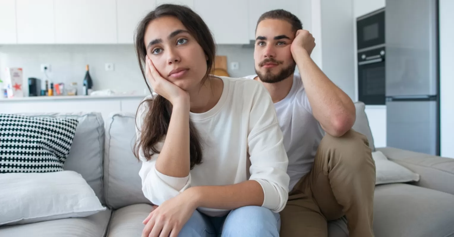 Person reflecting on uncertainty in a relationship connected to signs someone is putting on a facade in a