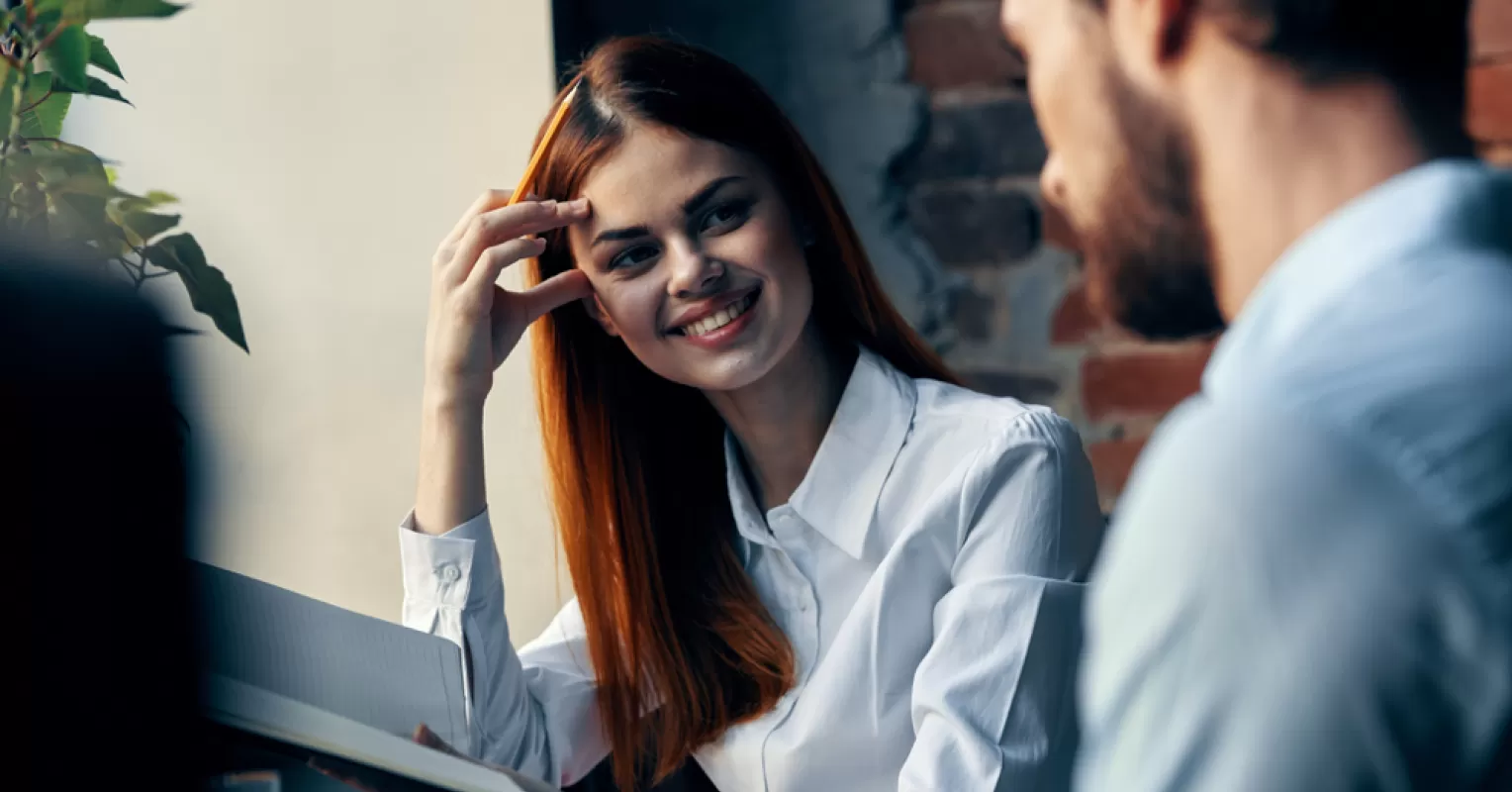 Couple embracing while a person appears distracted by their crush's presence