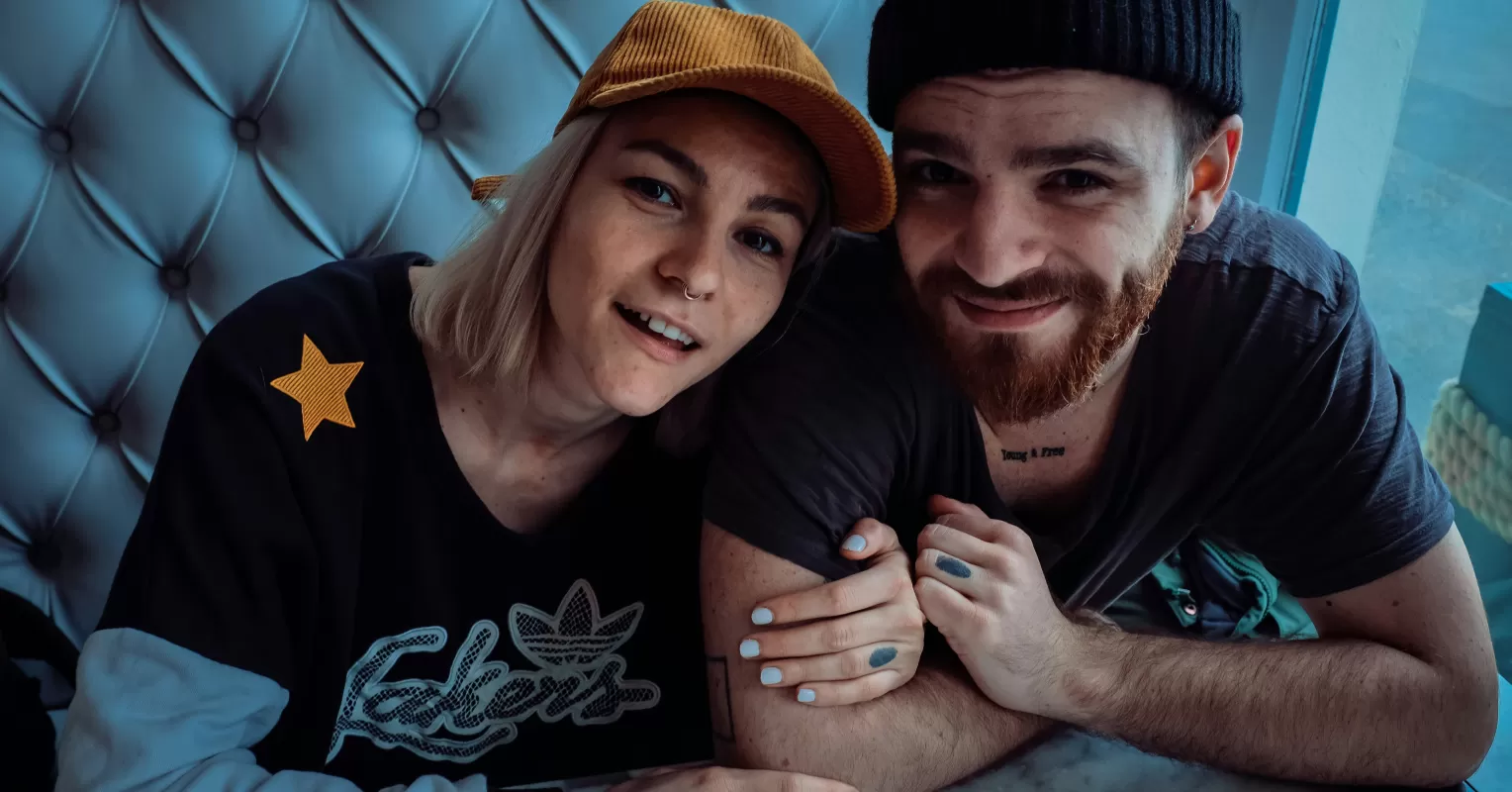 Couple sitting together, with one partner visibly introspective after a loss