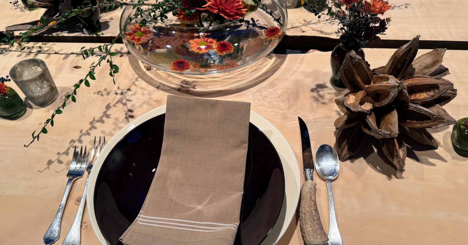 Person sitting alone at a table, feeling distant despite being grateful for loved ones