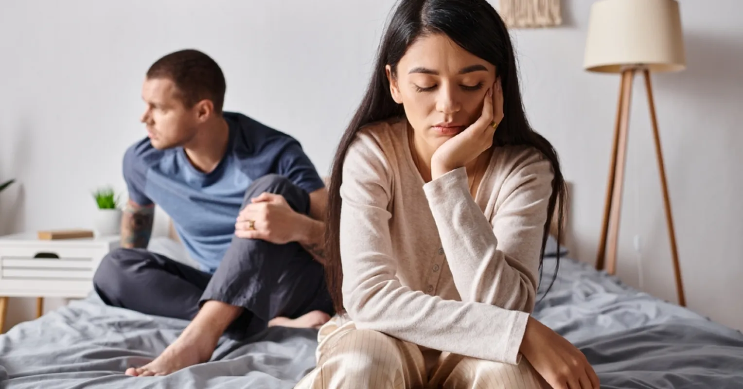 Couple sitting in silence, showcasing avoidance of deep conversations and emotional disconnect