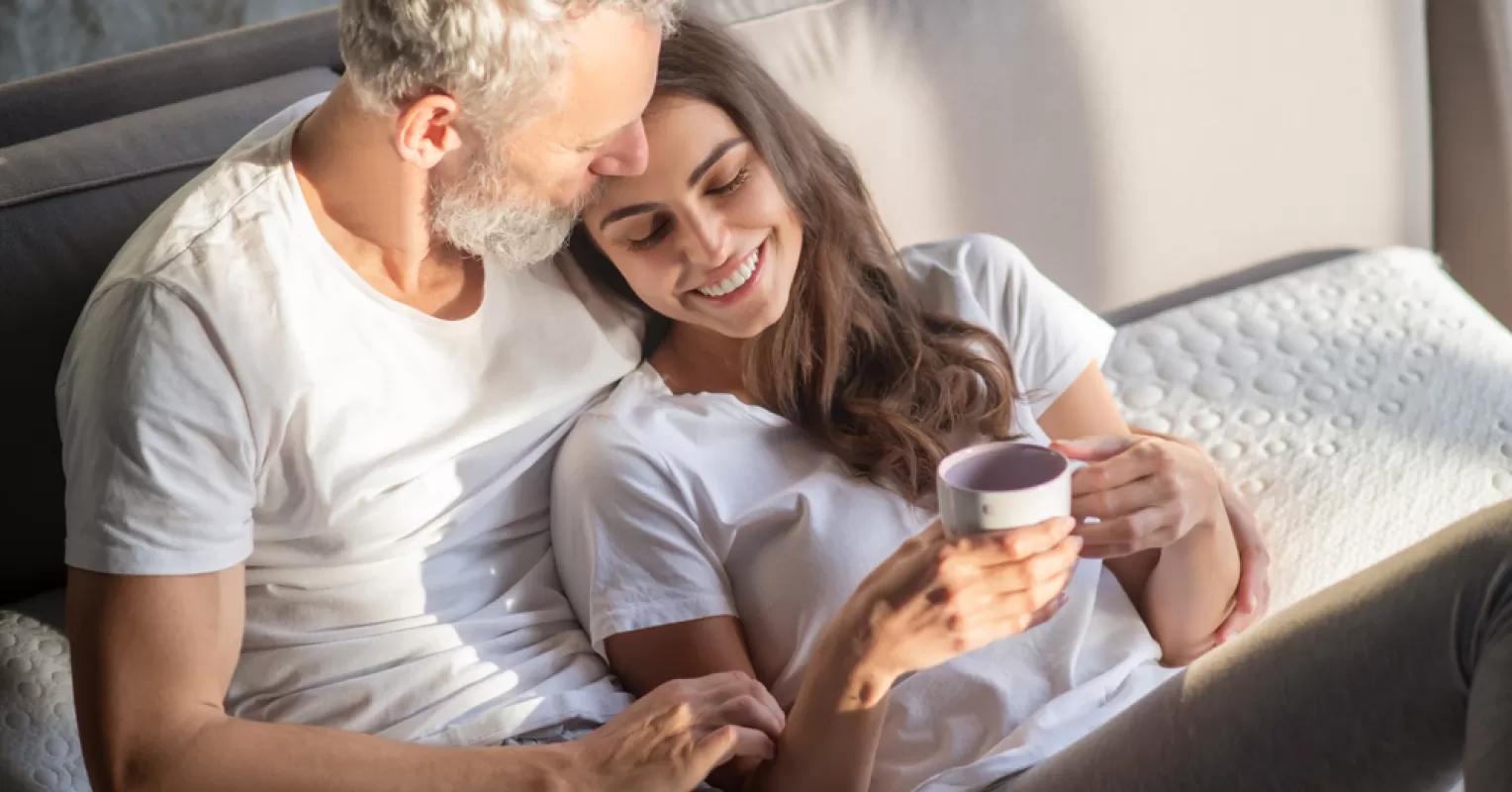 Couple discussing feelings of discomfort regarding their age difference in a cozy setting