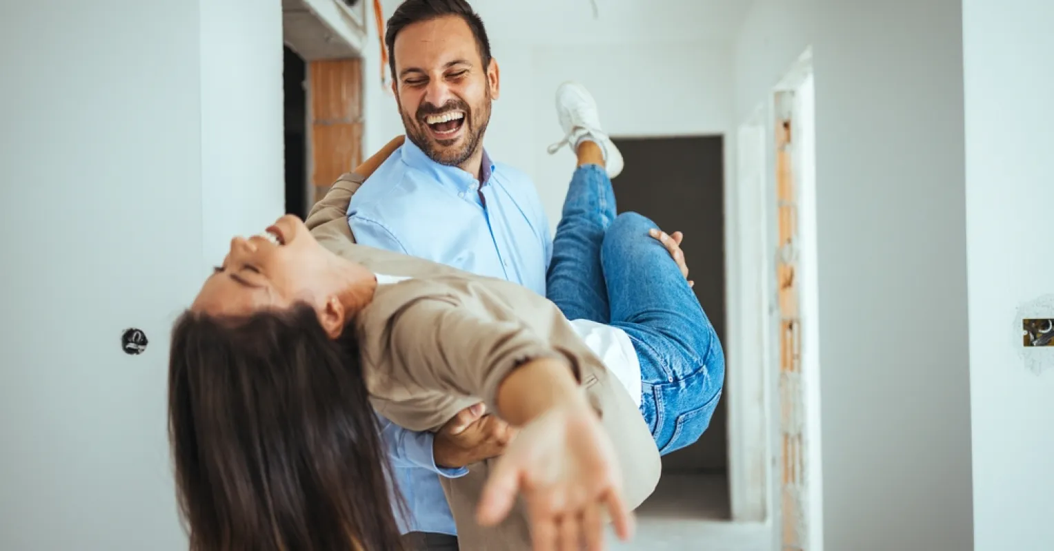 Couple interacting joyfully, embodying relationship signals where actions convey more than words