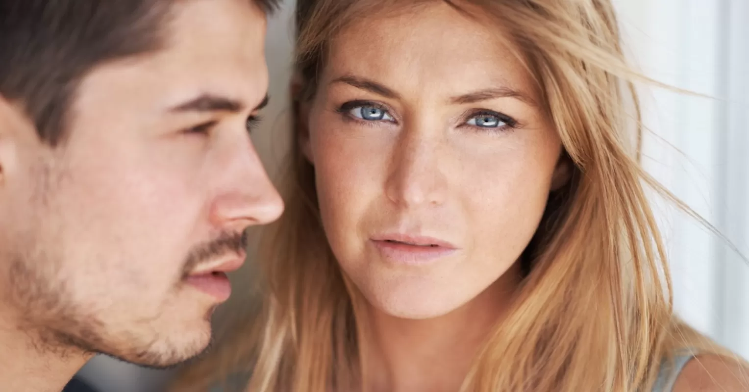 Couple taking a moment of pause during a heated discussion on relationship signals
