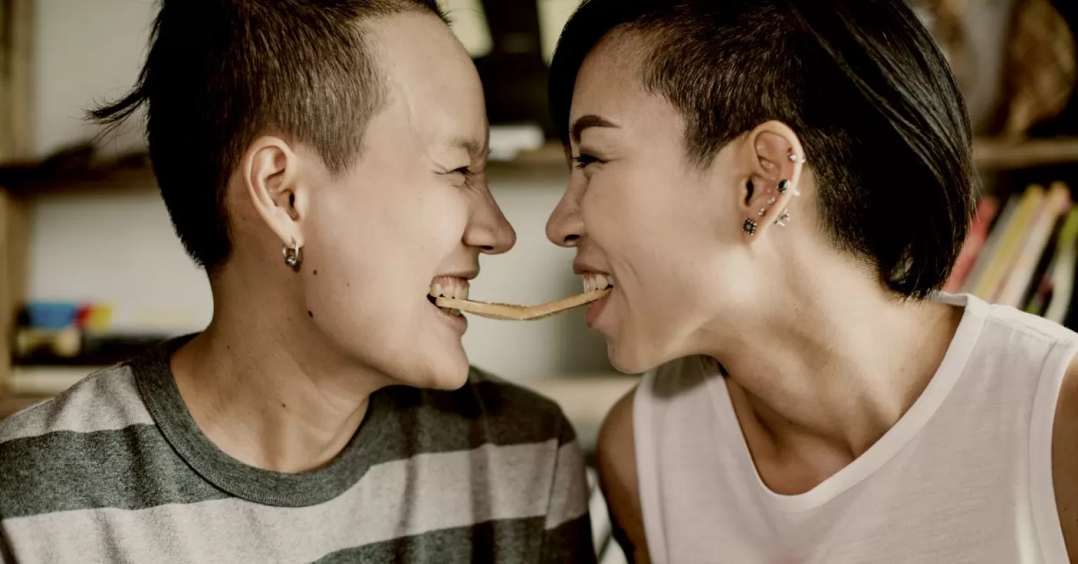 Couple sharing a moment of laughter, highlighting vulnerabilities in a supportive relationship