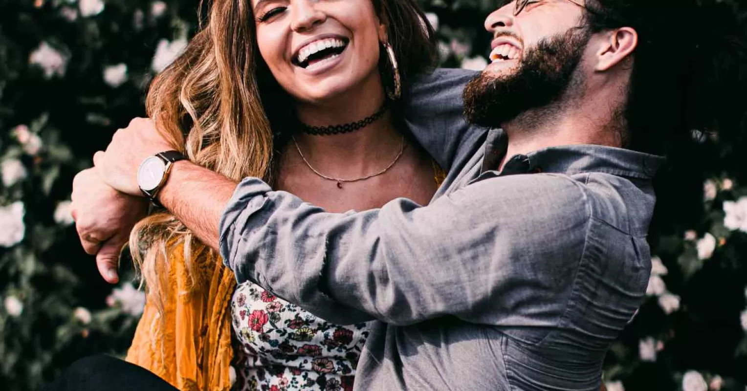 Couple laughing together, demonstrating how shared laughter enhances relationship quality.