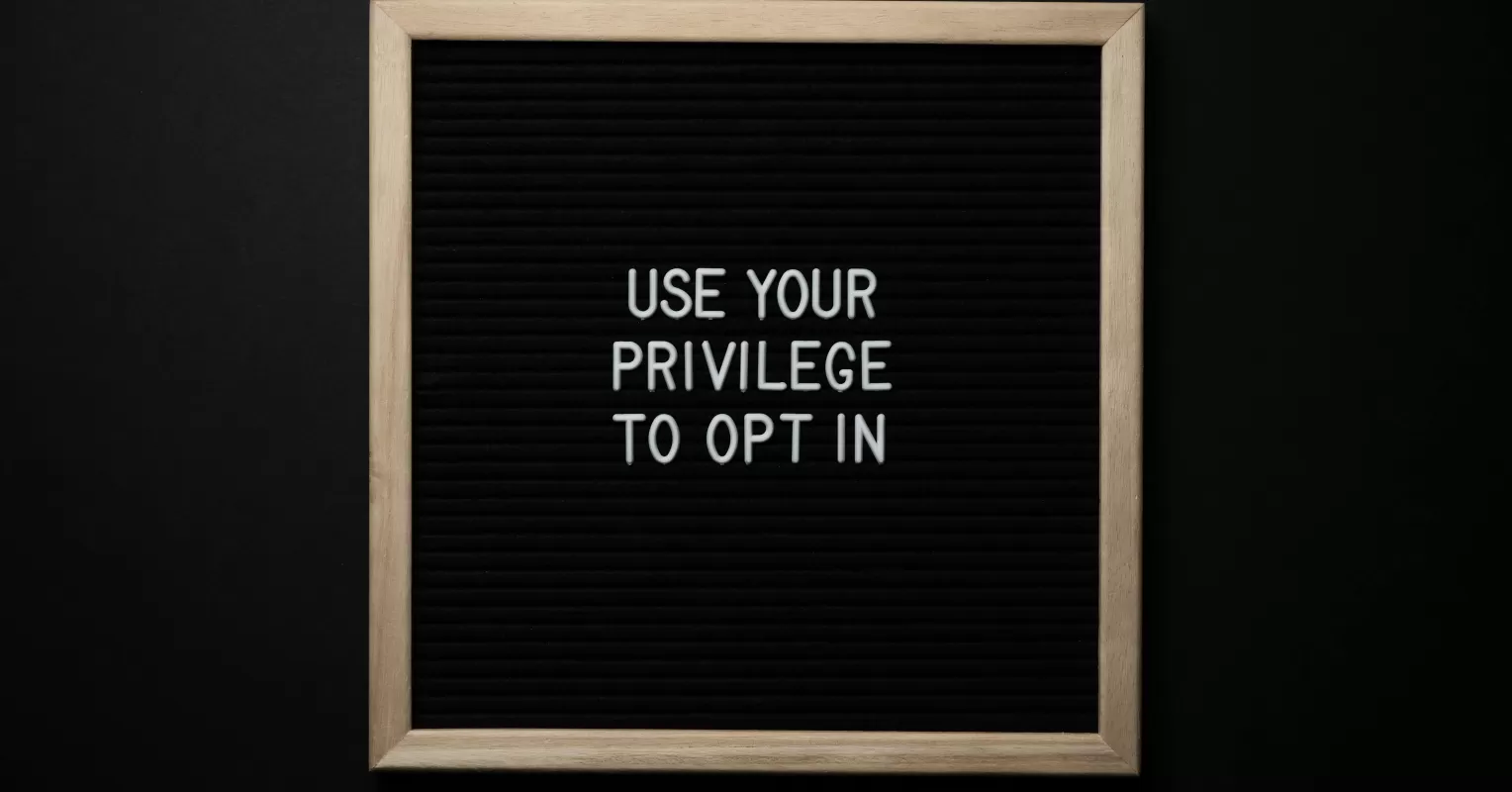 A person looking thoughtfully while discussing privilege in a group conversation