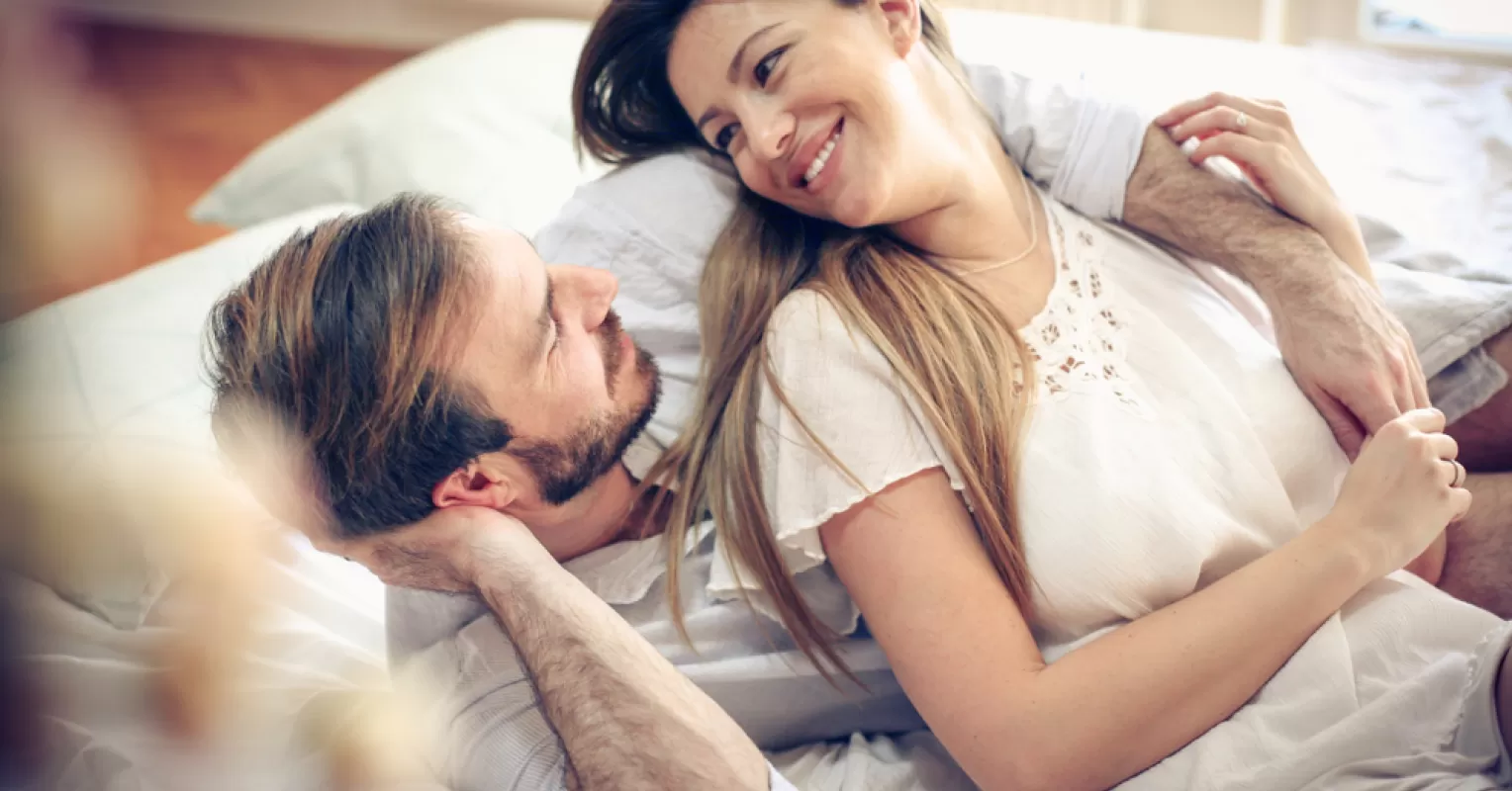 Couple sitting in silence, signaling discomfort about discussing their sex life