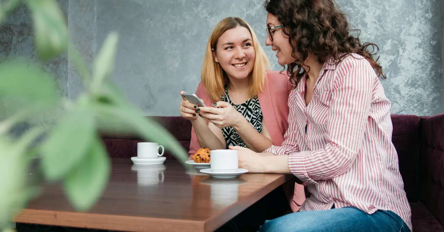 Couple sitting together but appearing distant during a conversation, highlighting disengagement.