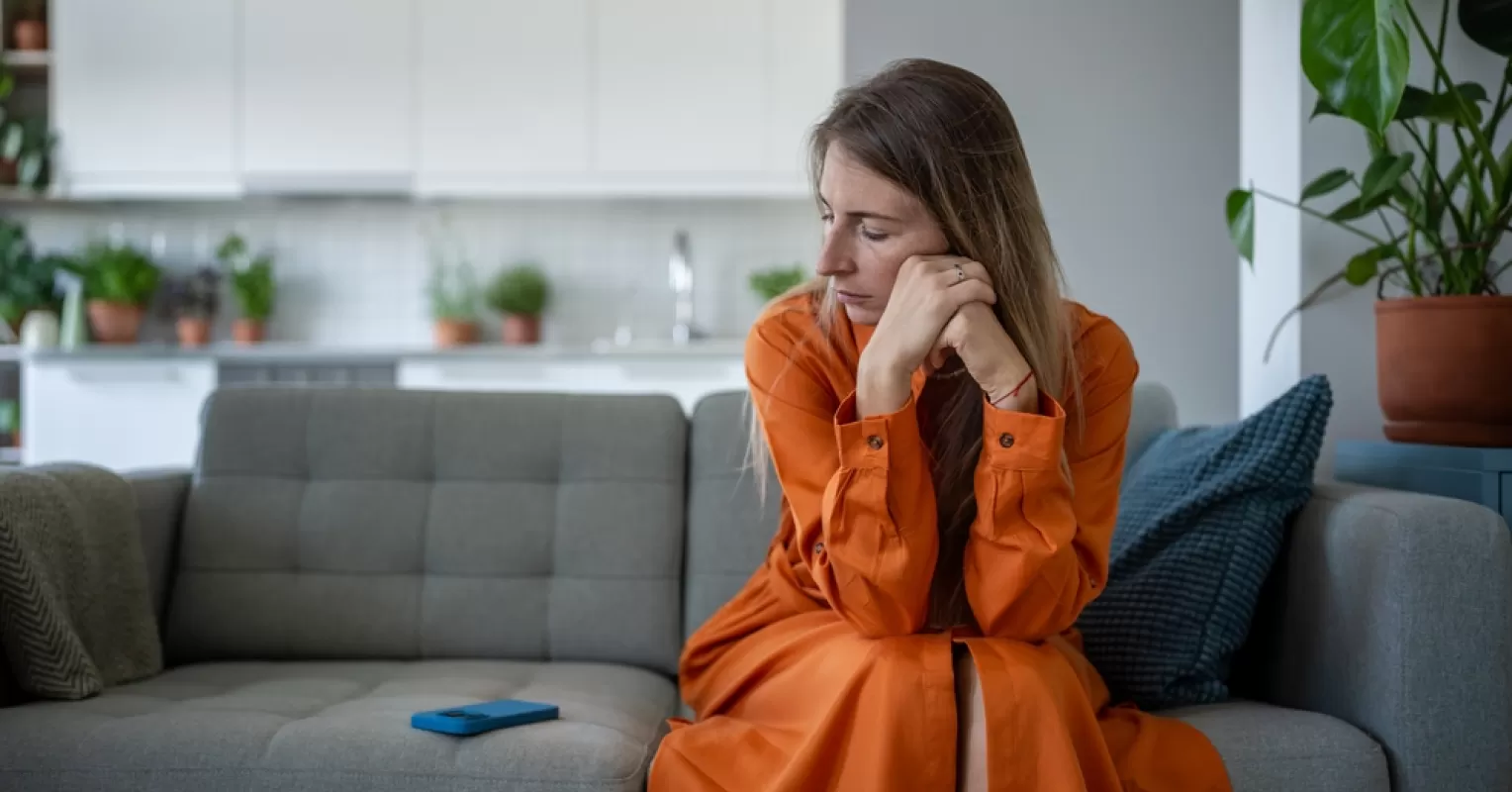 Adult child feeling conflicted about distancing from parents, showing emotional turmoil