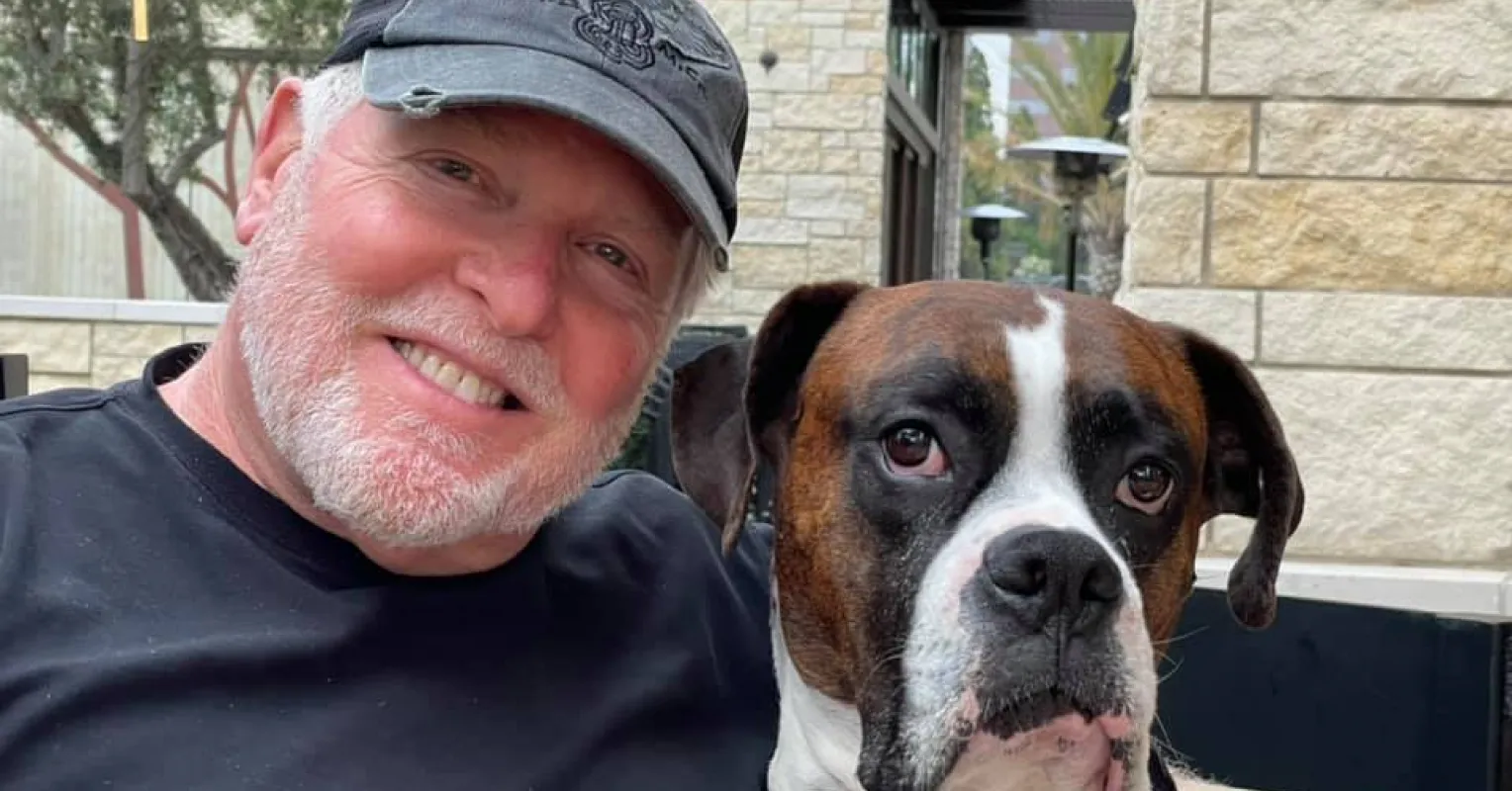Dog owner sharing a tender moment with their pet, highlighting emotional bond and social dynamics