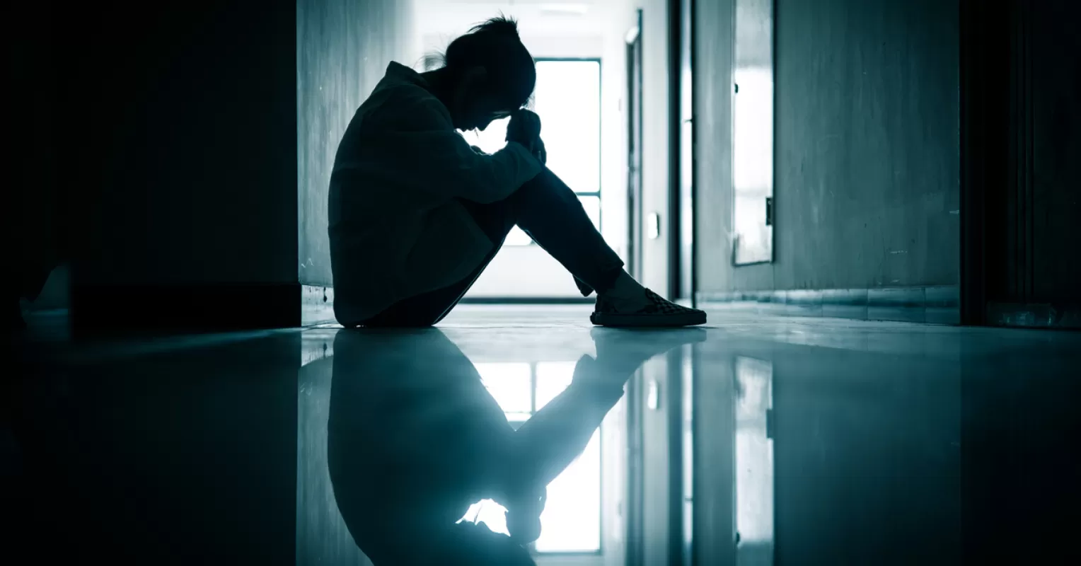 Individual hesitating to express feelings of grief in a conversation