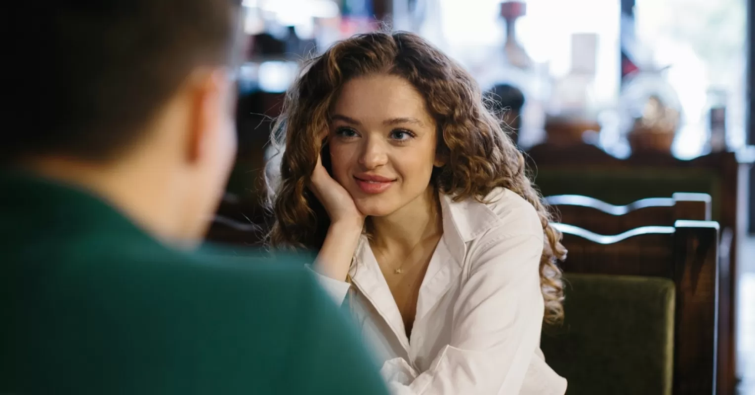 Person daydreaming about unreciprocated love while watching a sunset