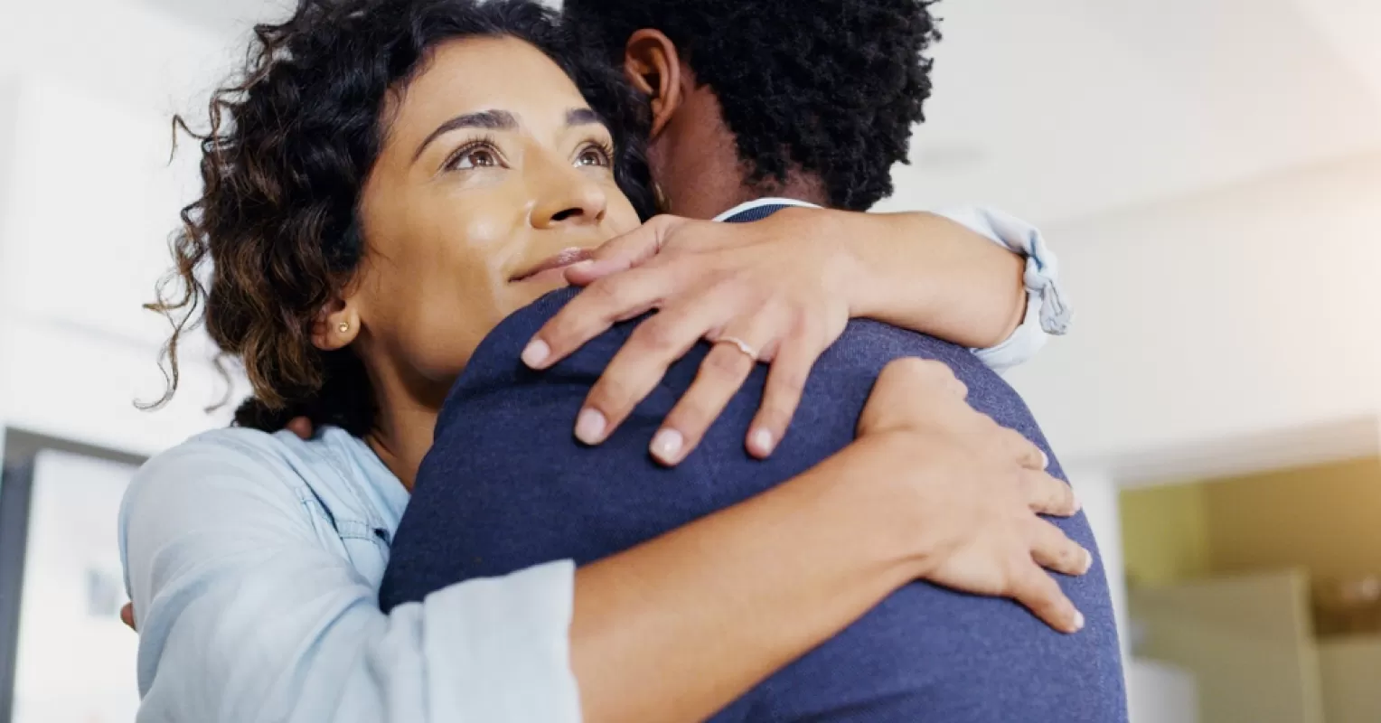 Person hesitates before embracing someone, feeling anxiety about expressing affection