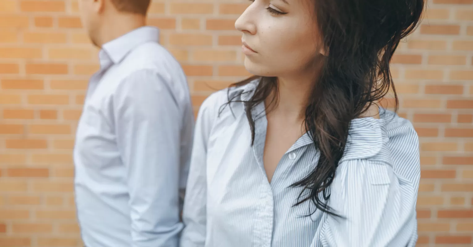 Individual gazing at their phone, feeling anxious about partner's texts and relationship signals