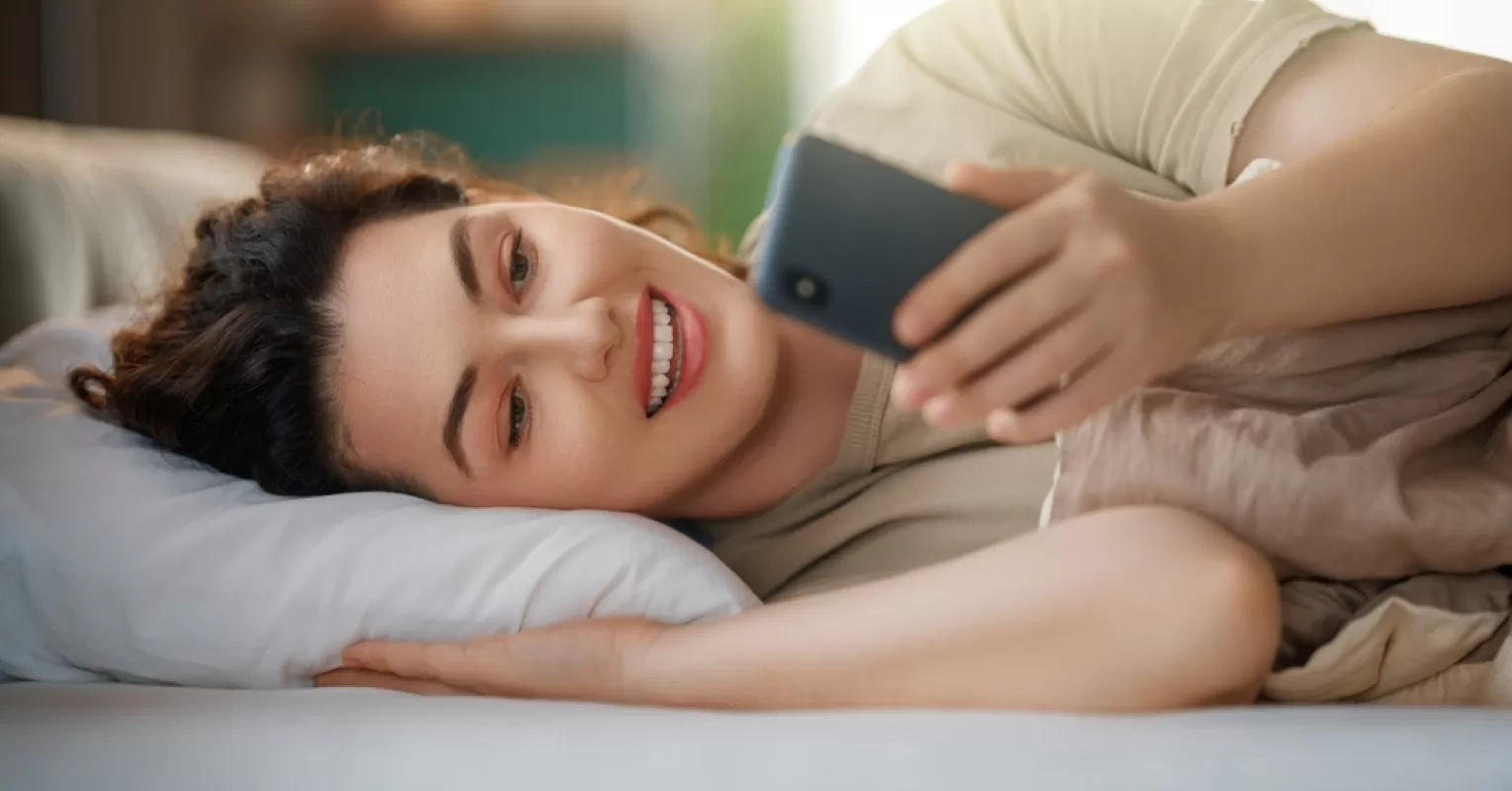 Person contemplating their feelings after a delay in receiving a text response