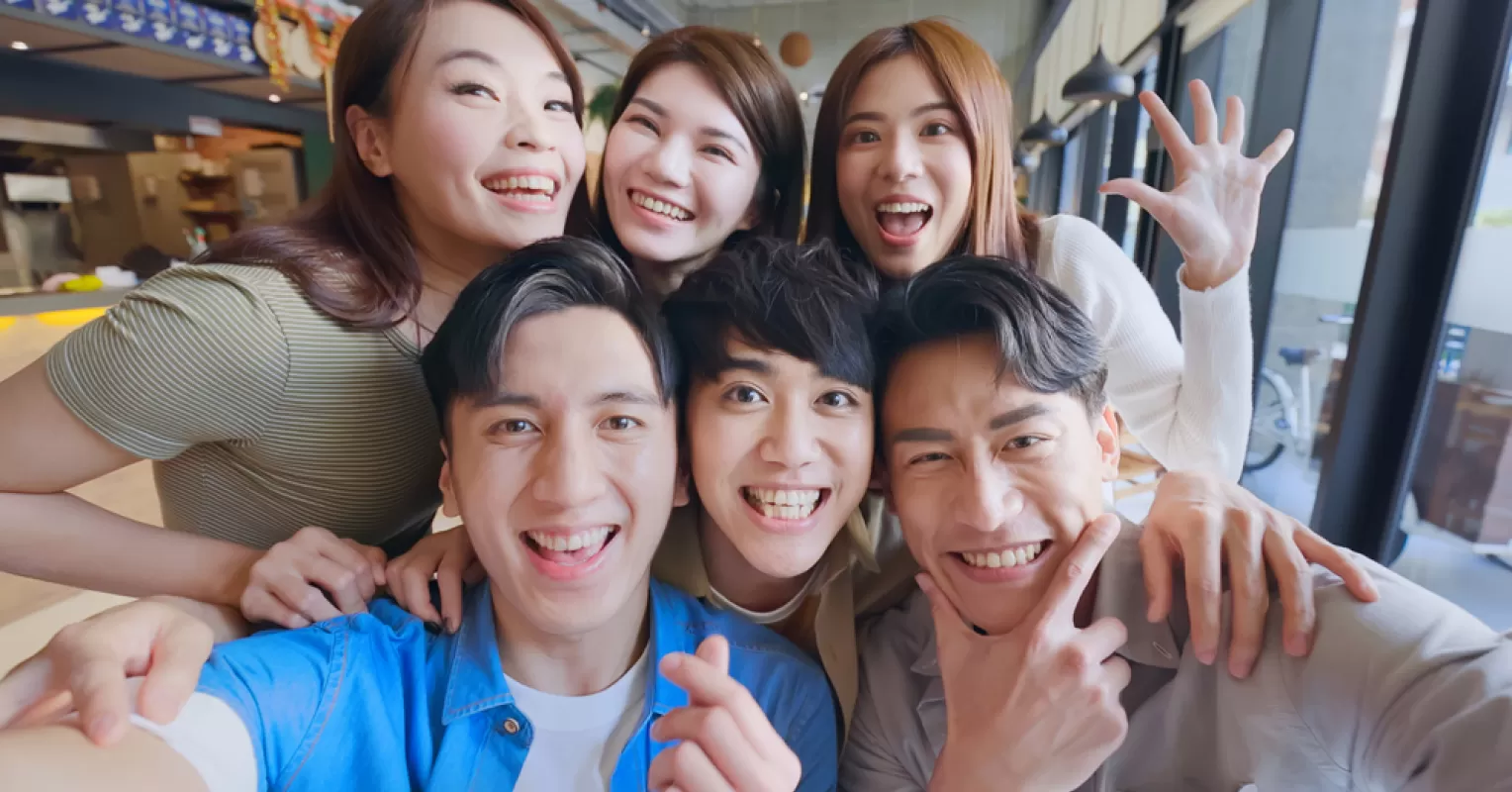 Group of friends interacting, showing varying degrees of openness and authenticity in social dynamics