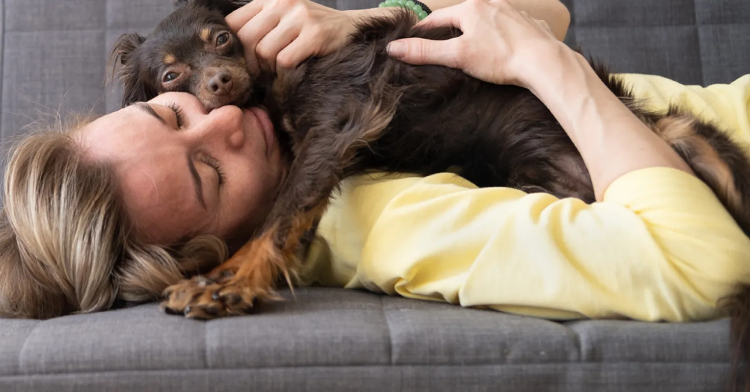A person enjoying time with their dog, feeling a surge of empathy and connection