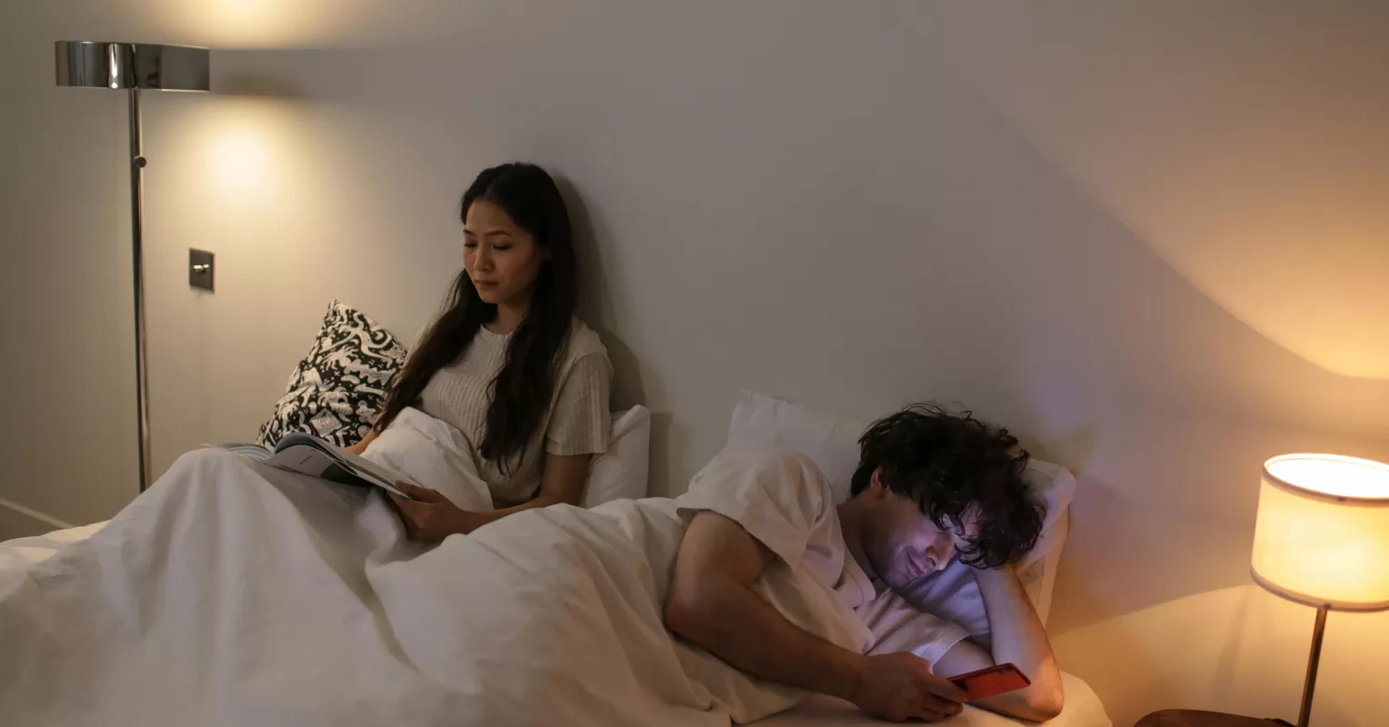 Couple sitting together, sharing a moment of friendship rather than intimacy in long-term relationship