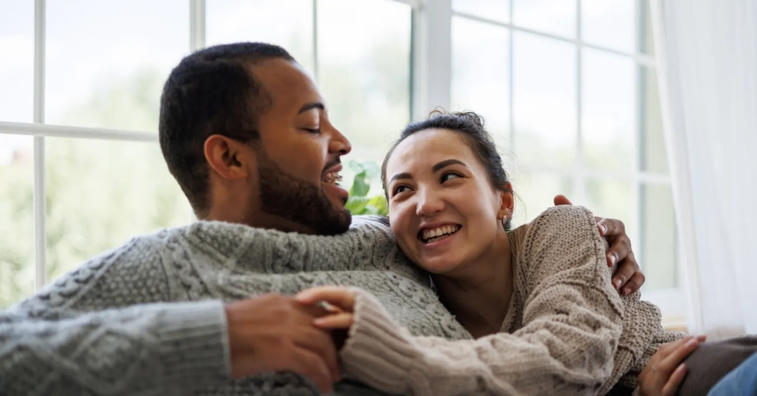 Couple sitting apart, experiencing emotional distance after a fight in their relationship