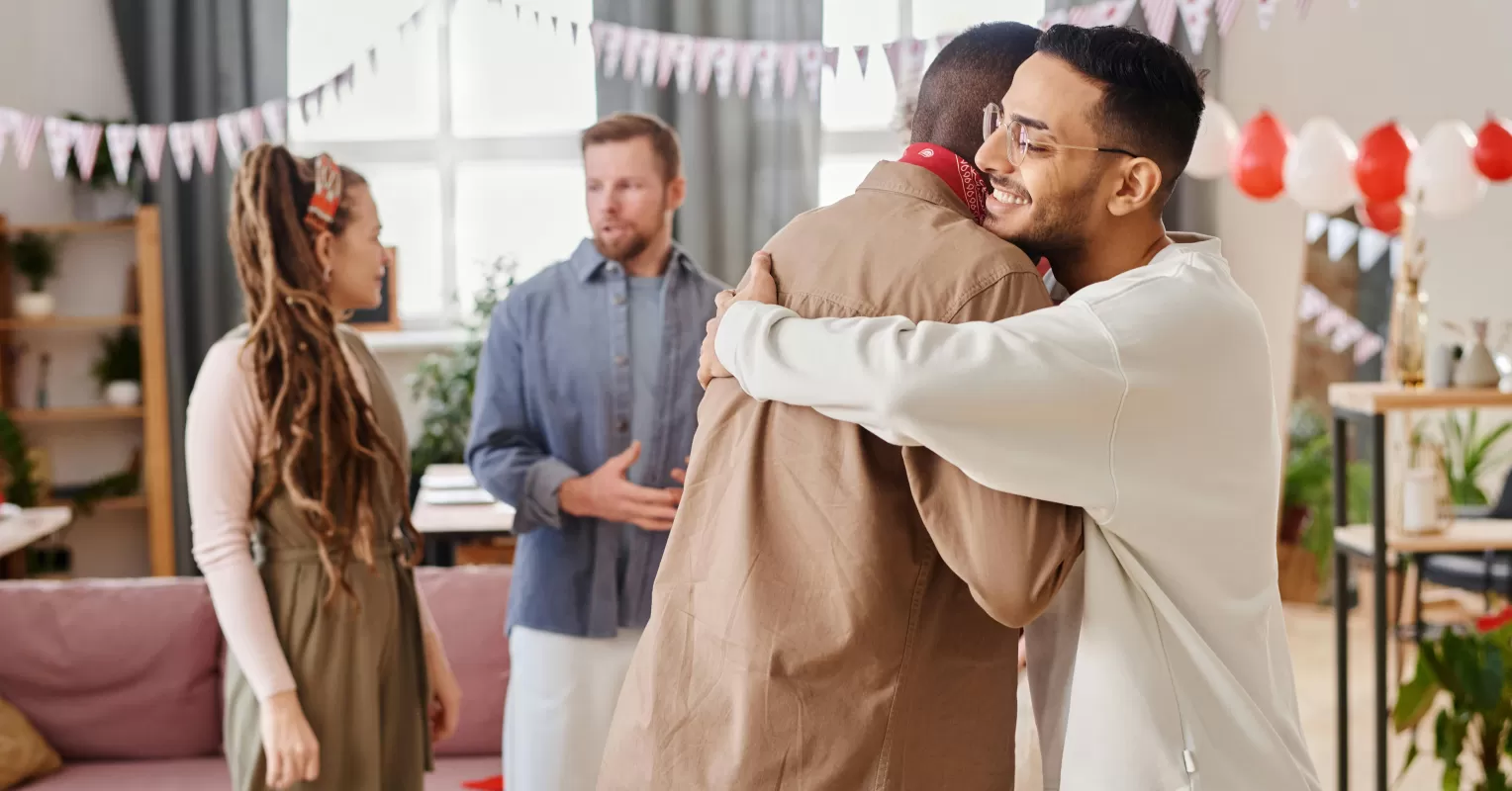 A person hesitating to hug a male friend, reflecting on social dynamics and comfort levels
